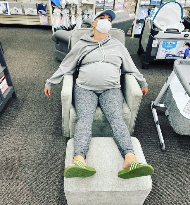Katy Perry pregnant and asleep in a baby shop