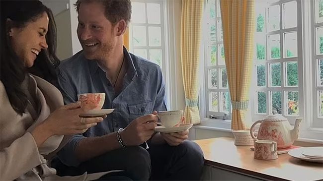 Meghan Markle and Prince Harry giggling while drinking tea