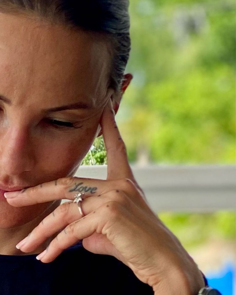 Lisa Zbozen wearing her engagement ring with her left hand on her face