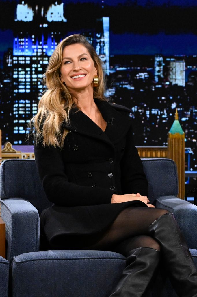 Gisele in black blazer and boots