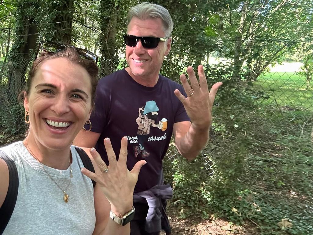 couple showing off wedding rings