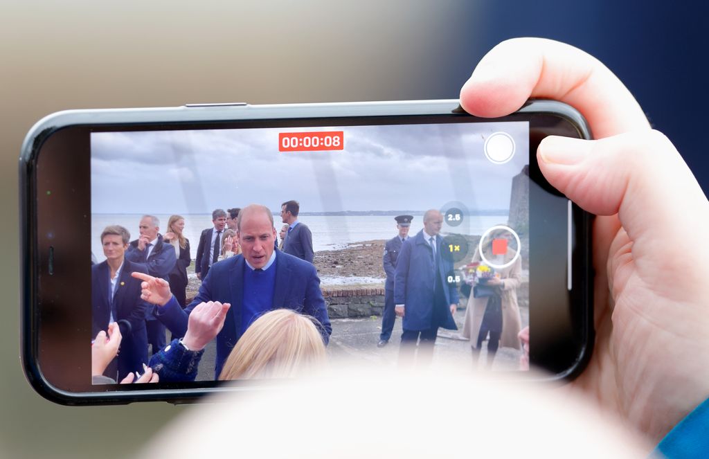 Prince William seen through a mobile phone camera