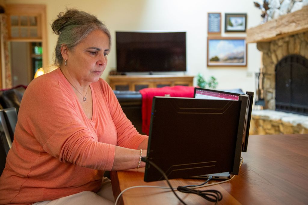 woman sitting at desk using laptop