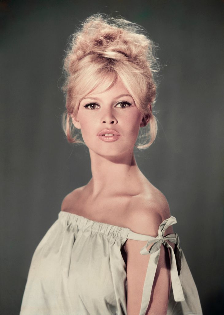 Studio portrait of actor and model Brigitte Bardot wearing a light blue off-the-shoulder dress.  (Photo by Hulton Archive/Getty Images)