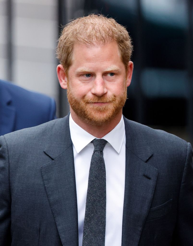 Prince Harry looking serious in a suit at court in London