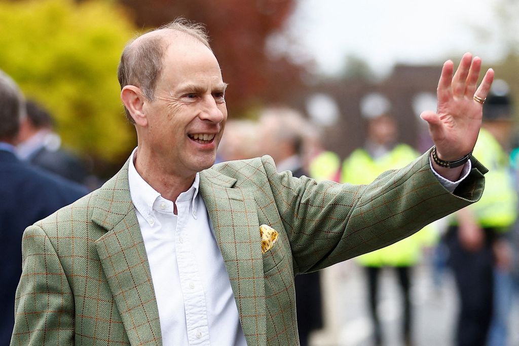 Prince Edward wearing green checked blazer and waving