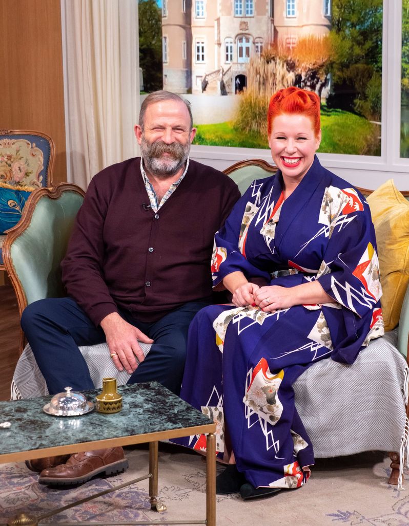 Dick and Angel Strawbridge sitting on a sofa