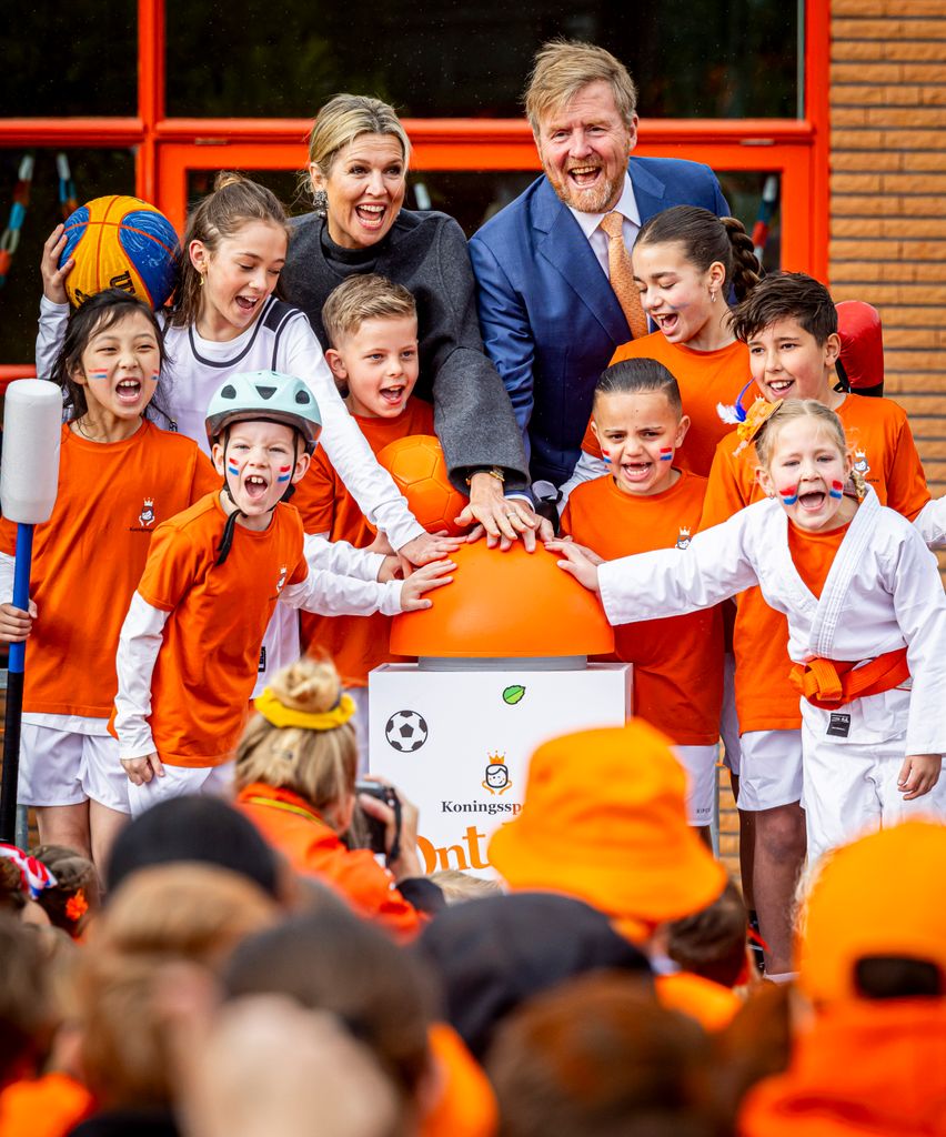 King Willem-Alexander and Queen Maxima with children cheering