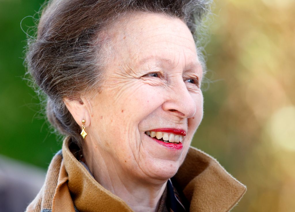 Princess Anne close up smiling in tan coat