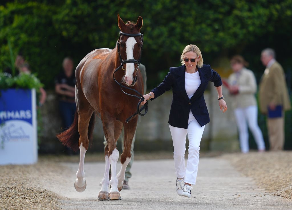 Zara Tindall running beside horse in skinny jeans 