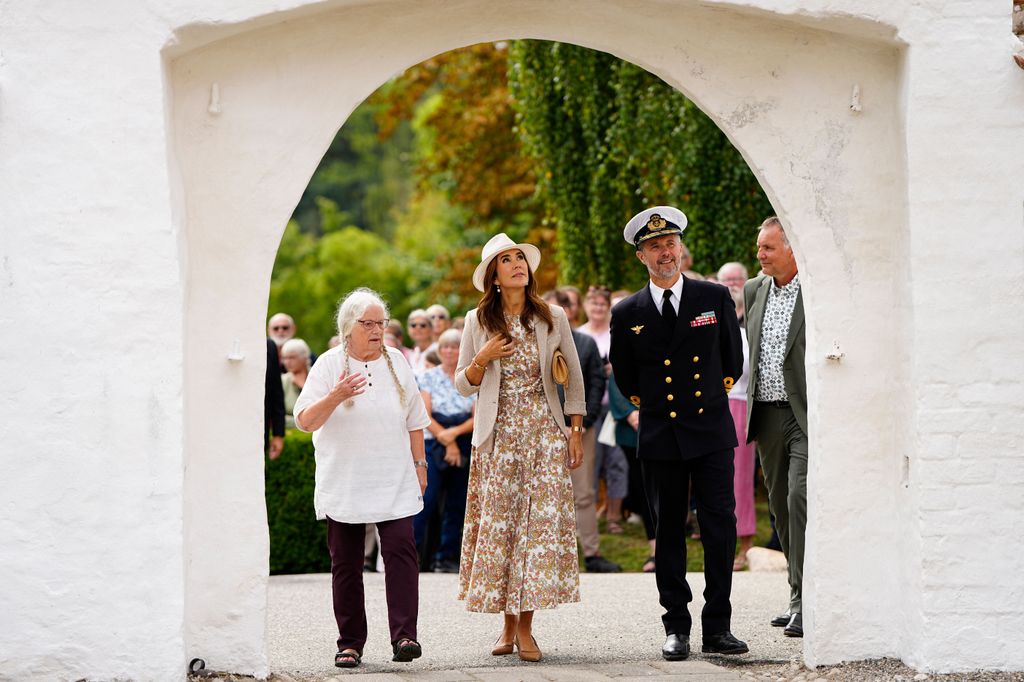 Denmark's Queen Mary (C) and King Frederik X (R) during a visit to Samsoe, Denmark