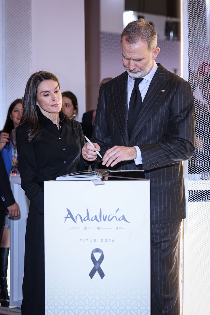 King Felipe of Spain signs a book of condolences in Madrid with wife Queen Letizia