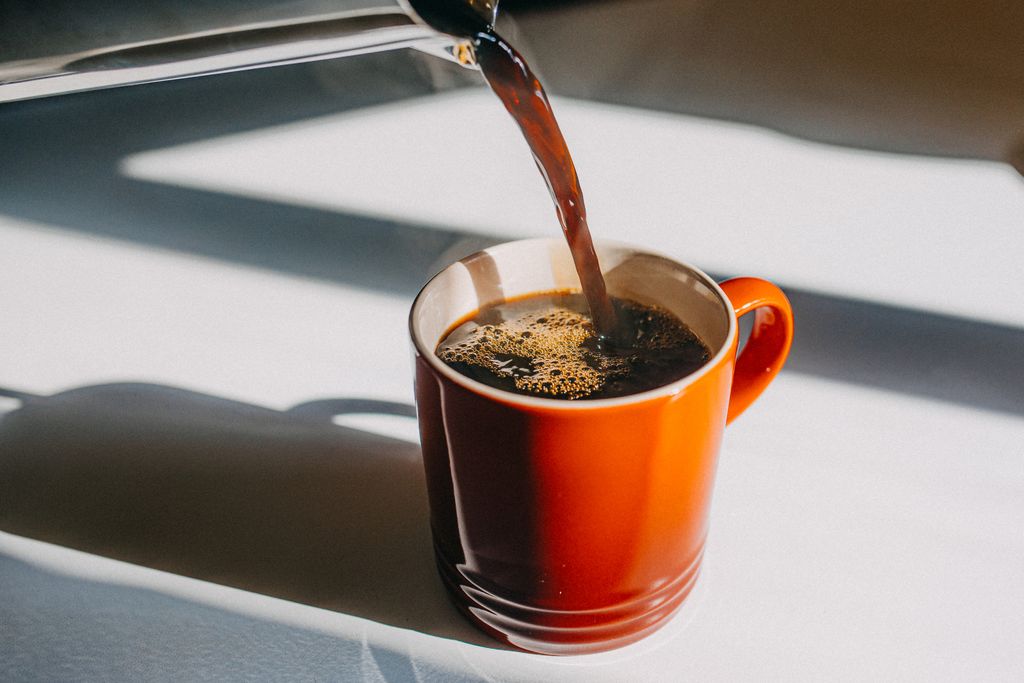 Functional coffee being poured into a mug