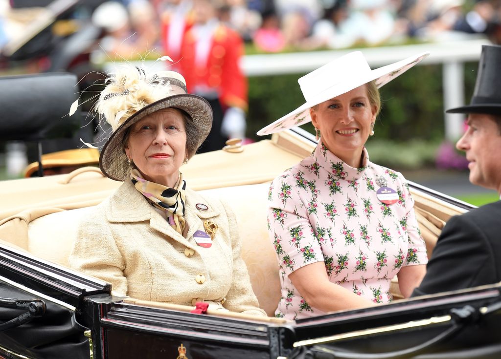 three people riding in carriage 