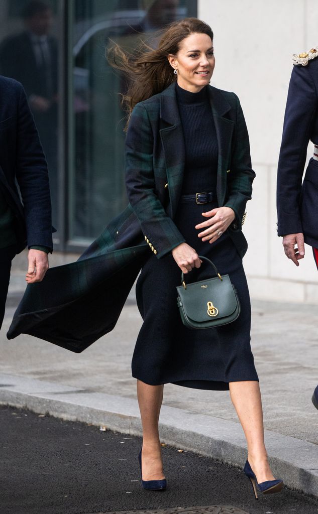 Kate walking in windswept coat