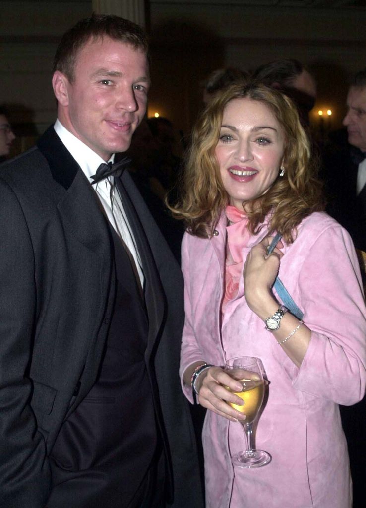 American singer Madonna carrying a Fendi handbag with her boyfriend British film director Guy Ritchie at the Evening Standard British Film Awards, held at the Savoy Hotel in London. *03/12/00 Madonna with her husband-to-be Guy Ritchie, who is planning to walk down the aisle in full Highland dress. The 32-year-old film director will marry the superstar wearing Hunting Macintosh Dress Tartan, it was reported. The outfit is believed to be tribute to his war hero grandfather Major Stewart Ritchie, who served with the Seaforth Highlanders, and his father John who also served in the Army. Ritchie has ordered his outfit from The Scotch House in Knightsbridge, London, it was reported.