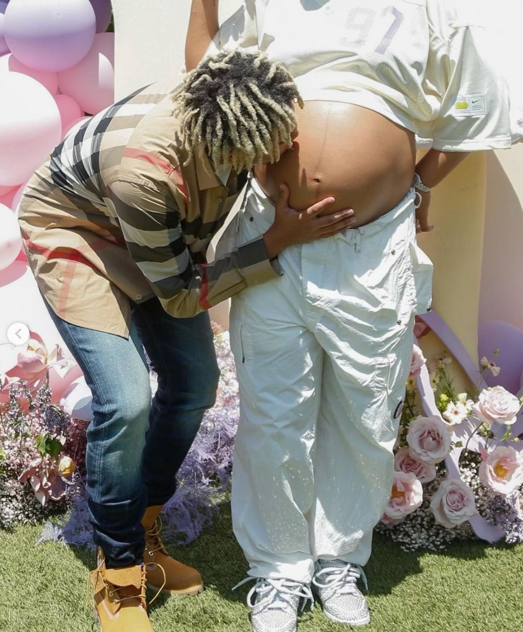 Photo posted by Naomi Osaka on Instagram June 2 2023 of her boyfriend Cordae kissing her baby bump at her baby shower.