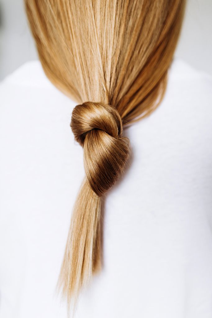 Beautiful healthy long hair tied in a knot.