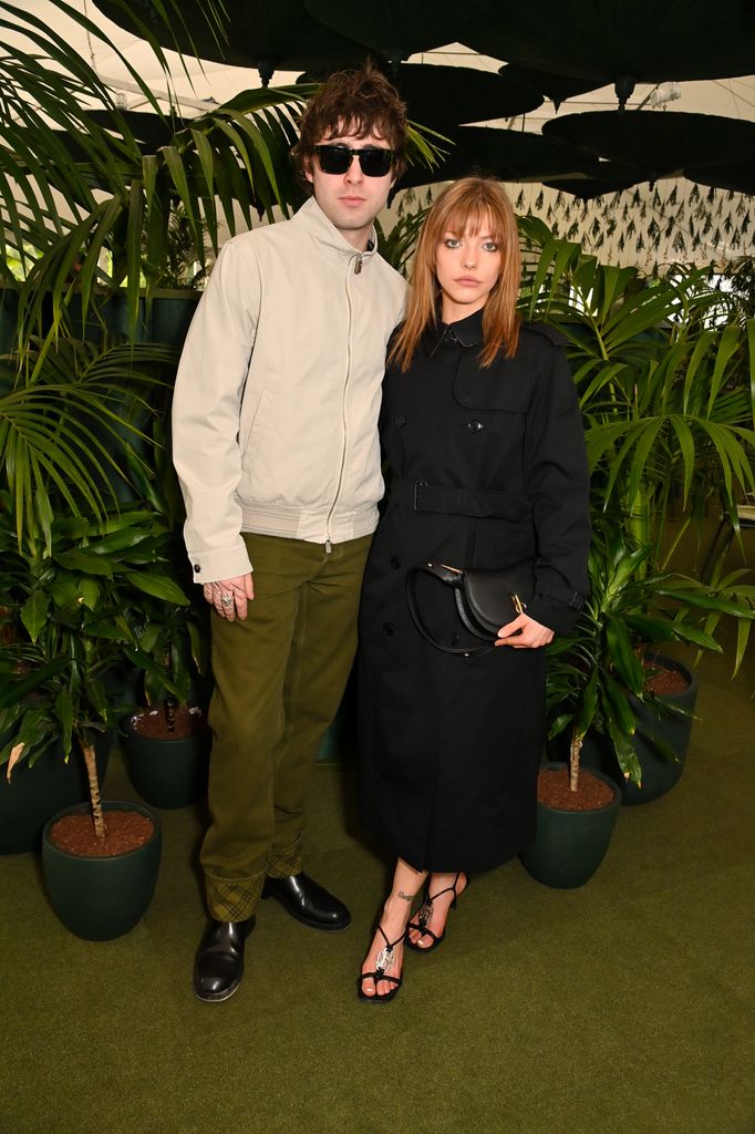 Lennon Gallagher in cream jacket and Isobel Richmond in black belted trench coat pose at Burberry x The Newt dinner during Chelsea Flower Show 2025.
