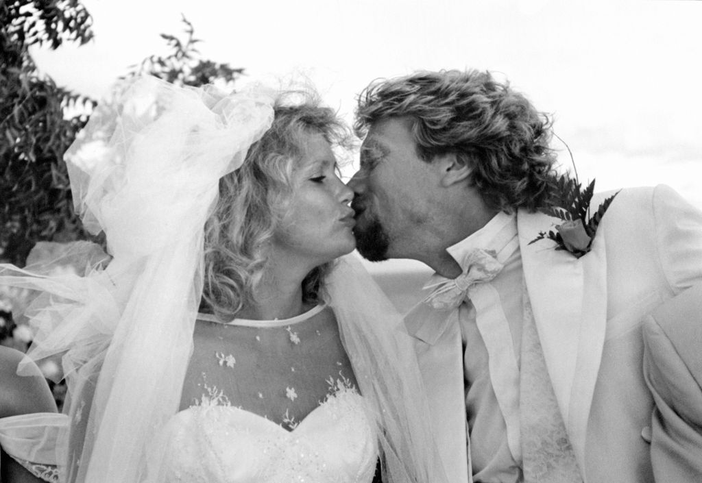 Virgin chairman Richard Branson kisses his bride, partner of 14 years, Joan Templeman at their wedding