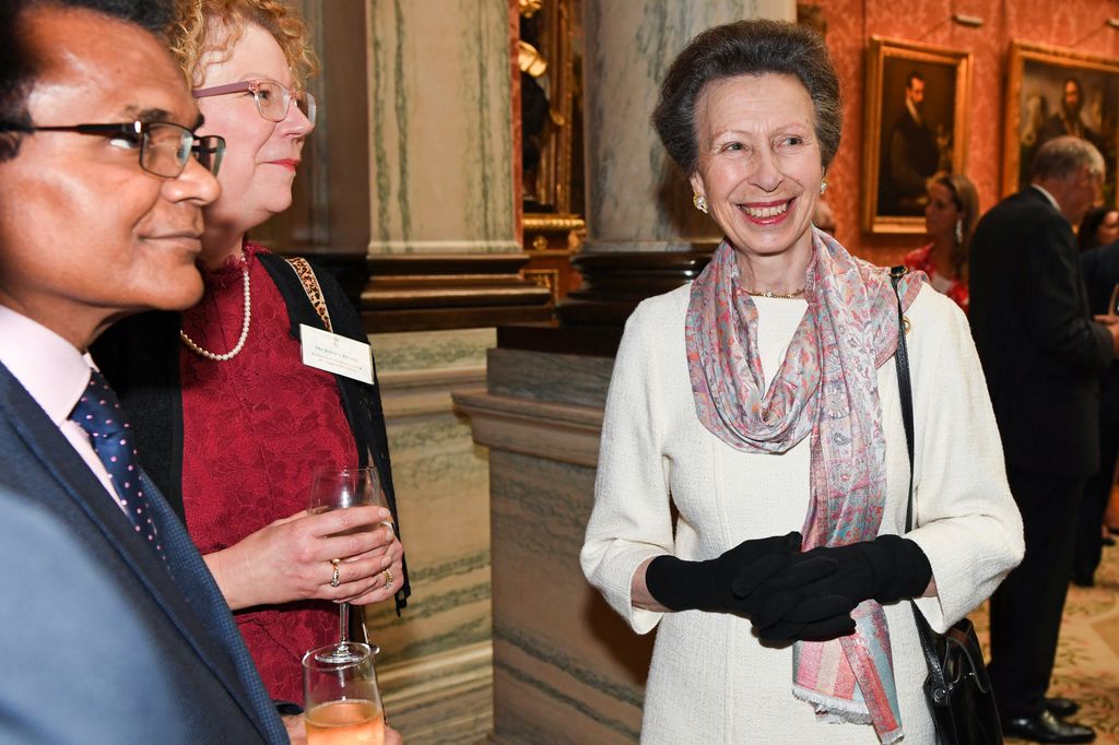 Anne, Princess Royal in white dress and gloves meeting people