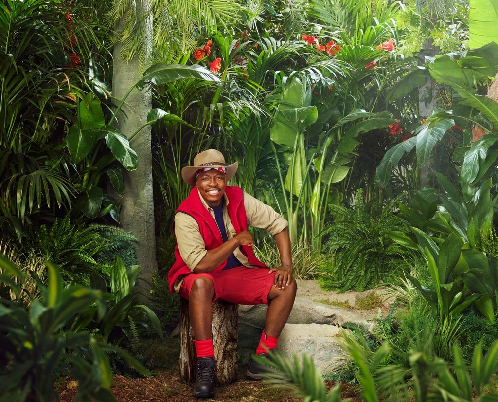 person in red and beige uniform in jungle setting
