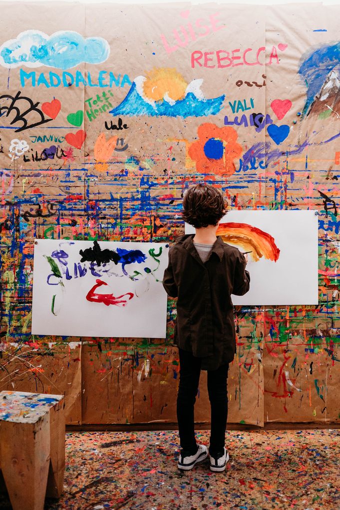 A boy painting a rainbow
