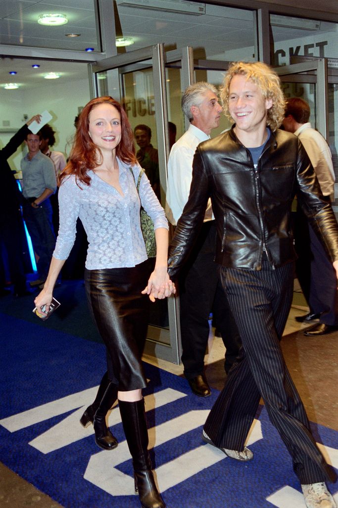 phot of heath ledger and heather graham holding hands