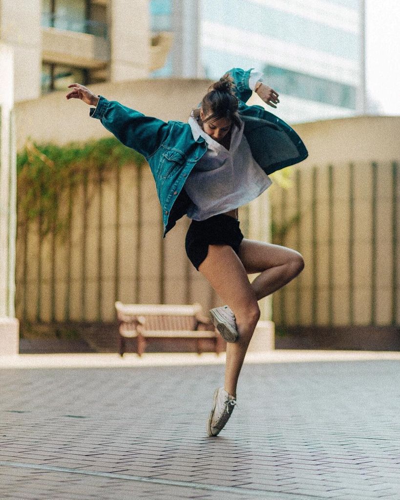 Woman dancing in a jacket 