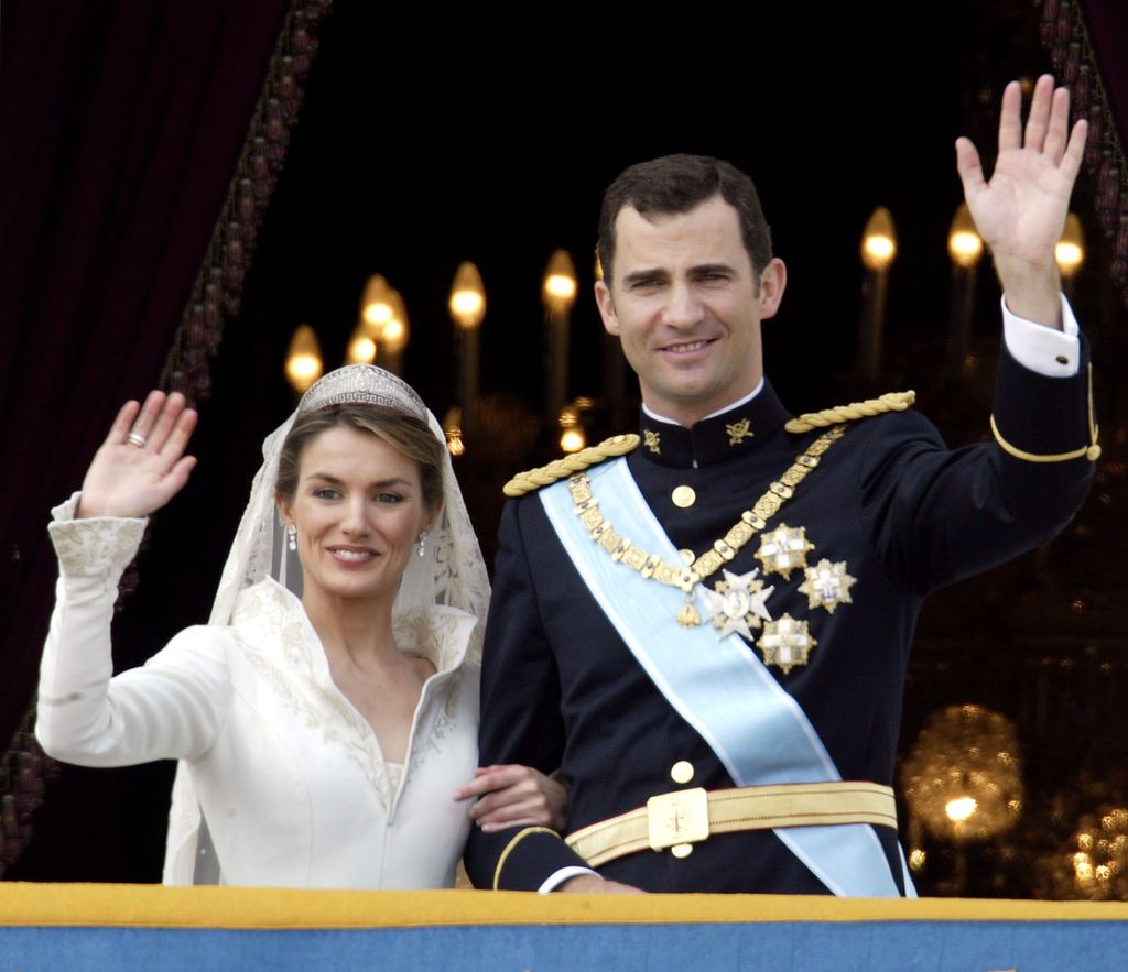 The royal couple wave from the palace balcony on their wedding day