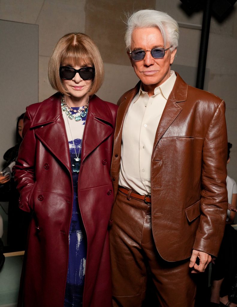 Anna Wintour beside Baz Luhrmann in brown leather jackets