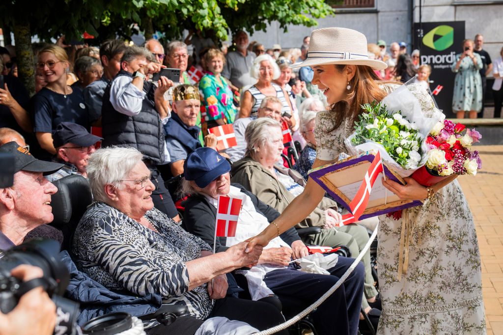 Queen Mary greets a member of the public in Grasten