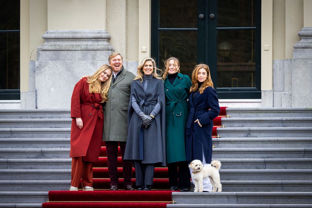 Princess Catharina-Amalia, King Willem-Alexander, Queen Maxima, Princess Ariane, Princess Alexia and a white dog on a set of stairs