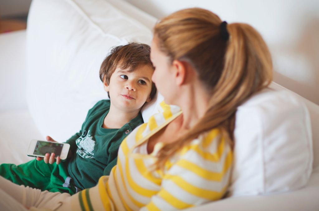 Small boy talking to his mother