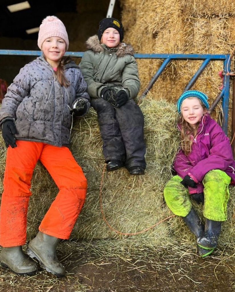 Three of Amanda and Clive's nine children posing at the farm