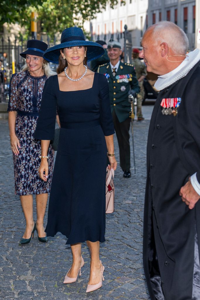 Queen Mary in navy dress and hat