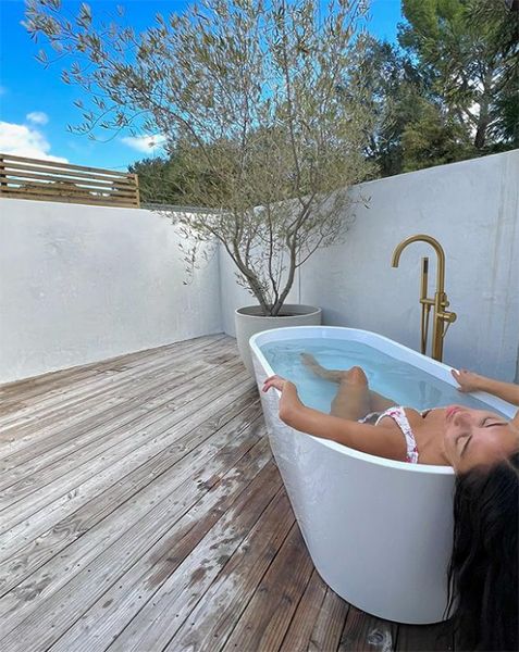 Nicole Scherzinger in outdoor bath in white bikini