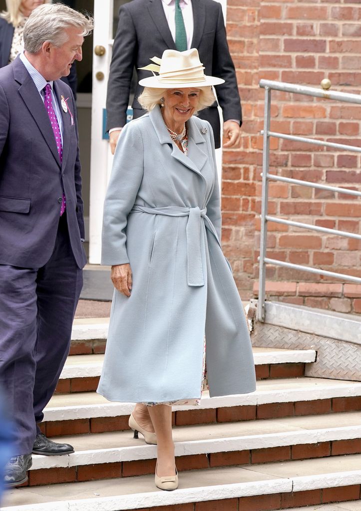 Queen Camilla smiling in blue coat at The Ebor Festival