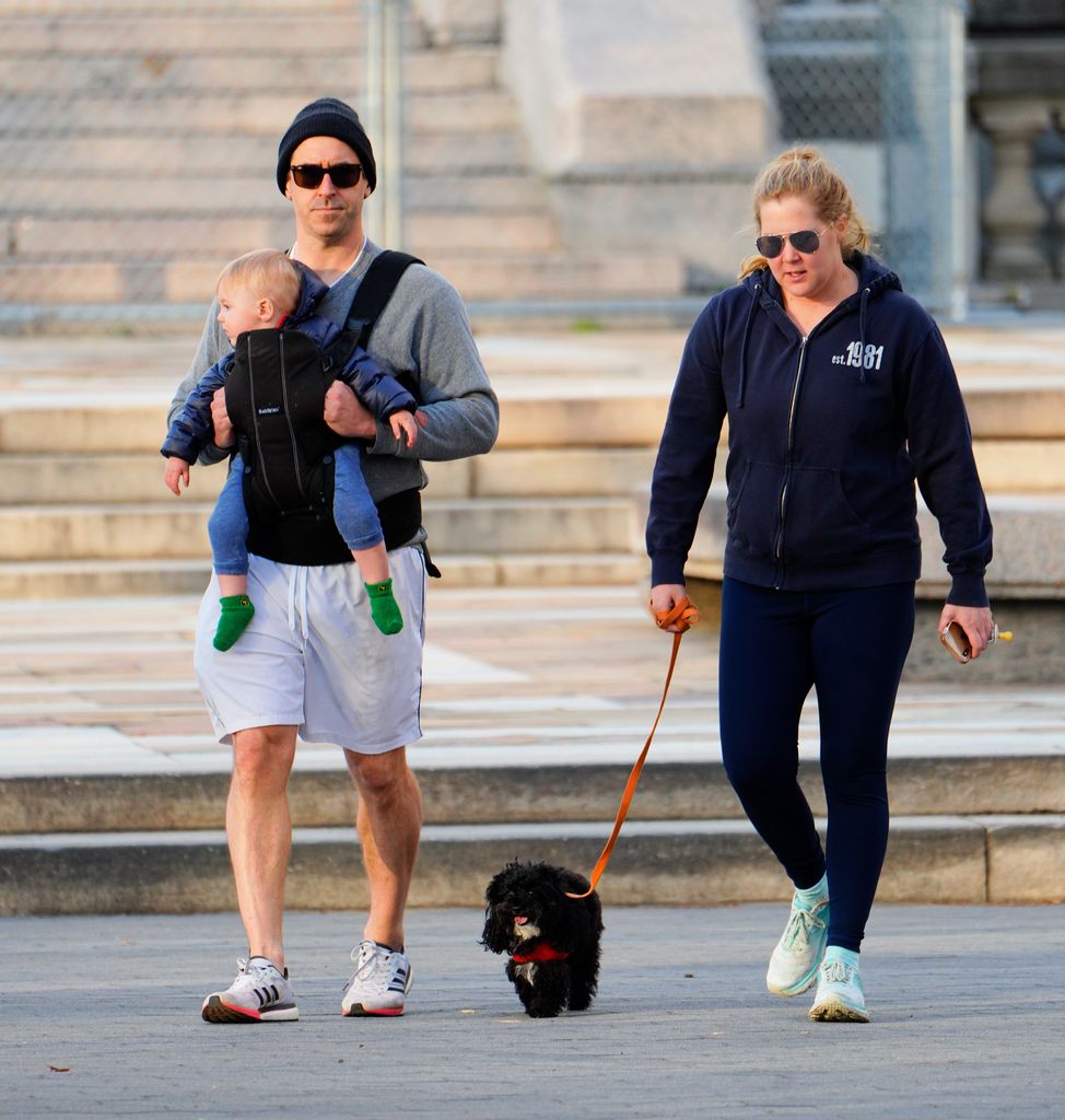 amy walking in park with son gene and family dog