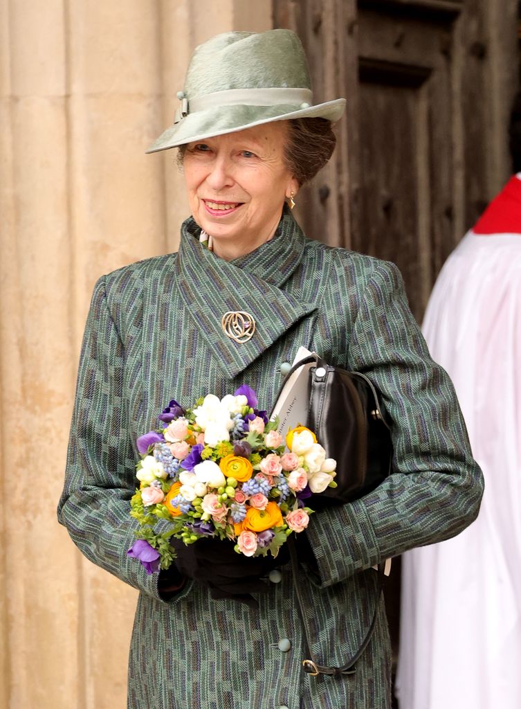 Princess Anne holds a bouquet of flowers as she steps out for the Commonwealth Day Service