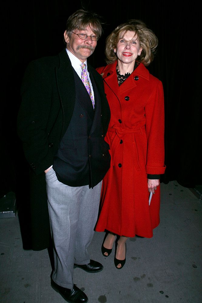 Christine Baranski wearing a red coat. She is pictured with her late husband Matthew Cowles, who is wearing a black jacket and grey trousers. 