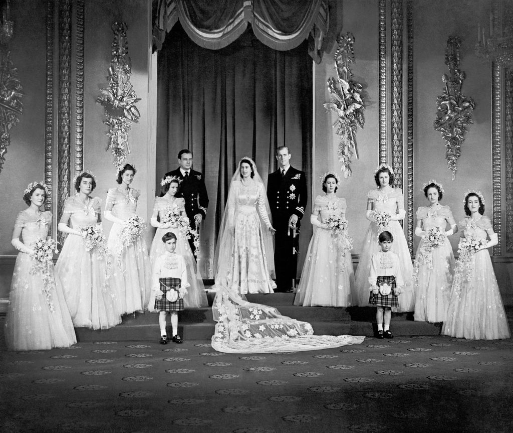 Princess Elizabeth and the Duke of Edinburgh with their eight bridesmaids in the Throne Room at Buckingham Palace