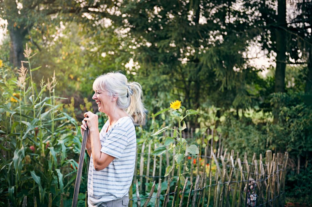 Mature woman working in her vegetable garden