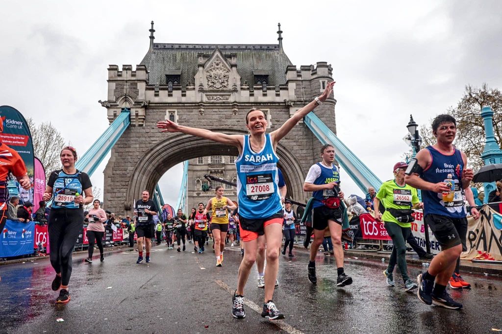 Woman running over Tower Bridge during the London Marathon 