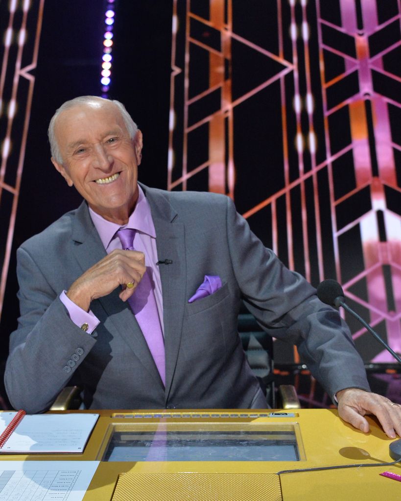 Len Goodman in a suit sat at the judges tables on Dancing with the Stars