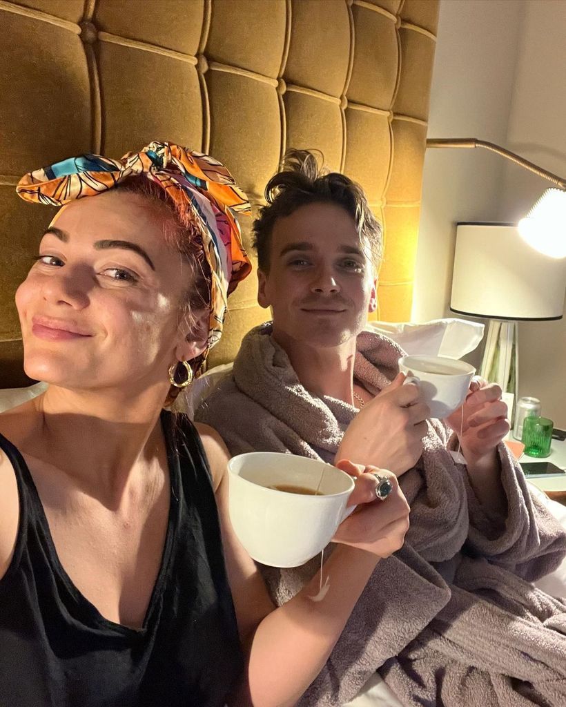 Dianne Buswell and Joe Sugg drinbking tea in bed