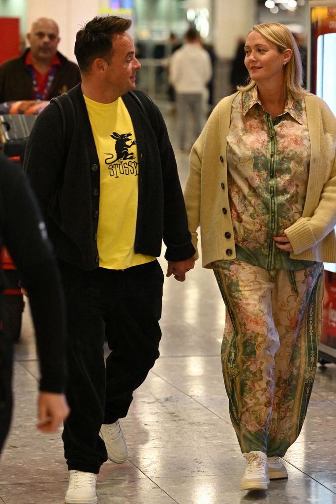 Ant and his wife Anne-Marie holding hands at the airport