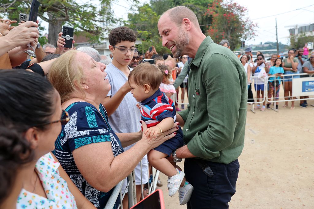 Prince William held 10-month-old Joaquim Monteiro.ceremony while on the island 