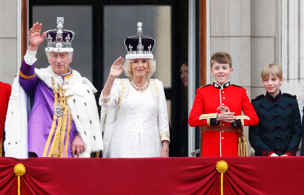 King Charles III, Queen Camilla, Freddy Parker Bowles and Gus Lopes watch an RAF flypast following the coronation