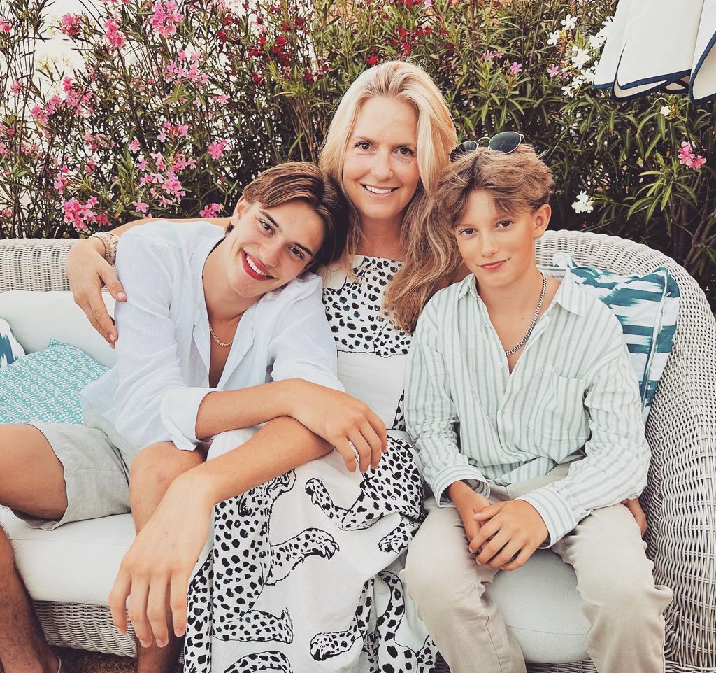 mother posing with two sons during summer